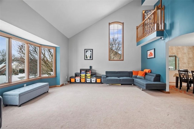 sitting room featuring high vaulted ceiling, carpet flooring, and baseboards