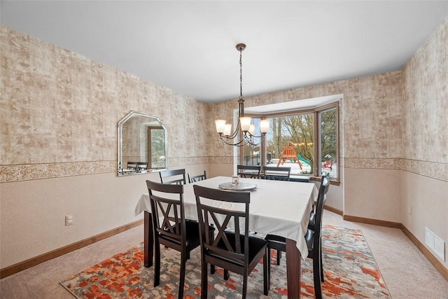 dining room with arched walkways, visible vents, light carpet, a chandelier, and baseboards