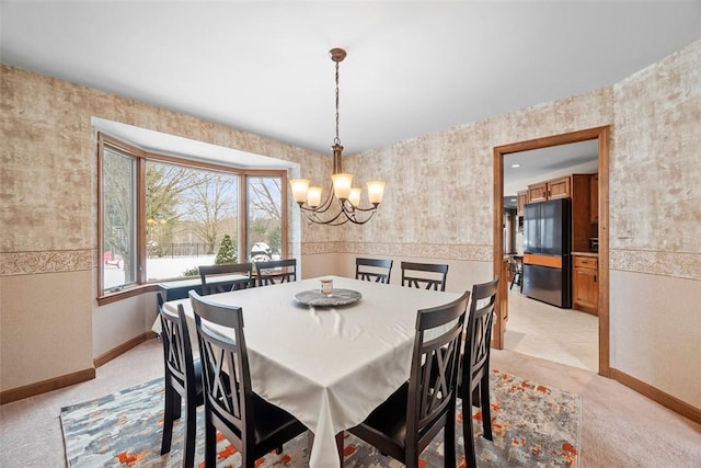 dining space with light carpet, baseboards, and an inviting chandelier