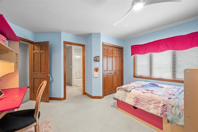 carpeted bedroom with baseboards and a closet