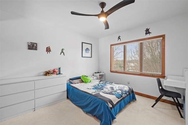 carpeted bedroom with baseboards and a ceiling fan