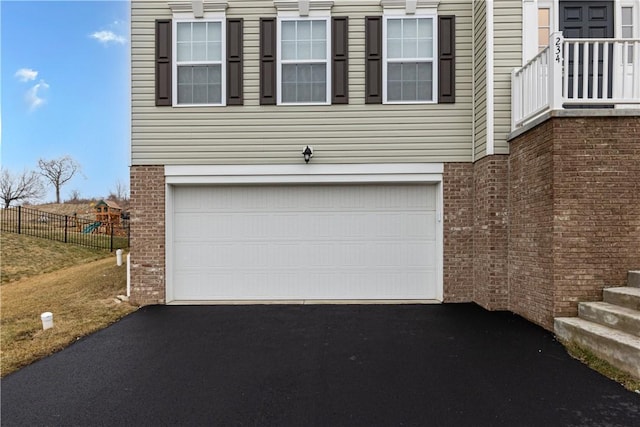 exterior space featuring fence and aphalt driveway