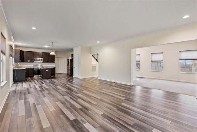 living room with recessed lighting, baseboards, and wood finished floors