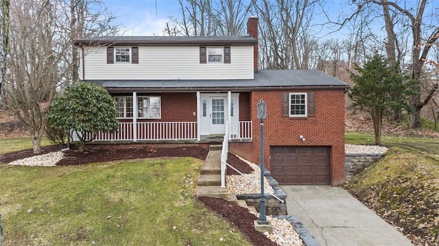 traditional-style home with driveway, a porch, an attached garage, a front lawn, and brick siding