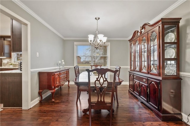 dining space featuring crown molding, dark wood-style flooring, baseboards, and a notable chandelier