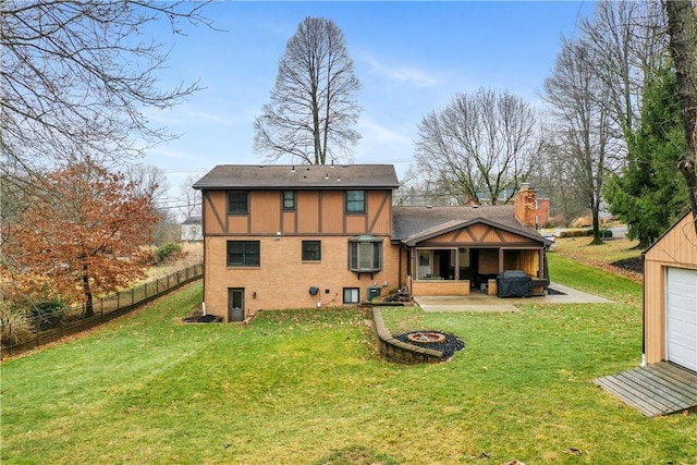 back of property with an outdoor fire pit, a patio, fence, a yard, and stucco siding