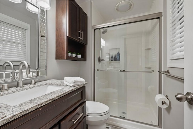 full bath featuring vanity, a shower stall, and toilet