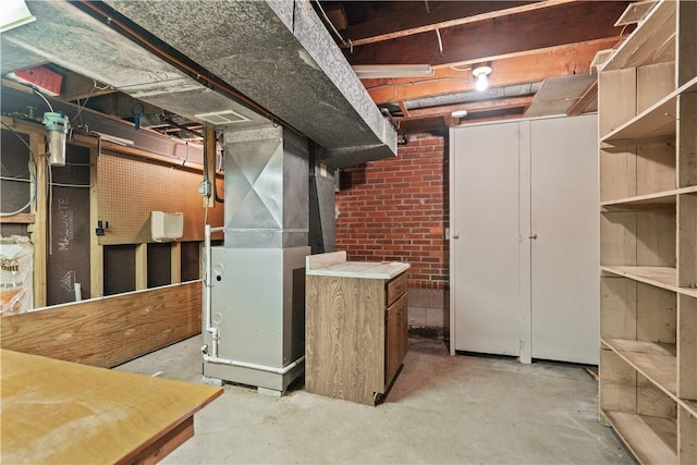 unfinished basement featuring heating unit