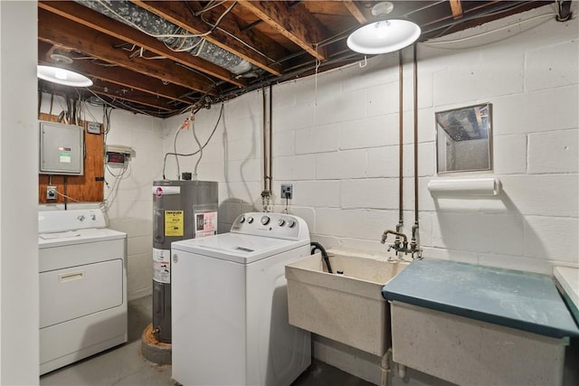 clothes washing area featuring washer and clothes dryer, water heater, a sink, laundry area, and electric panel