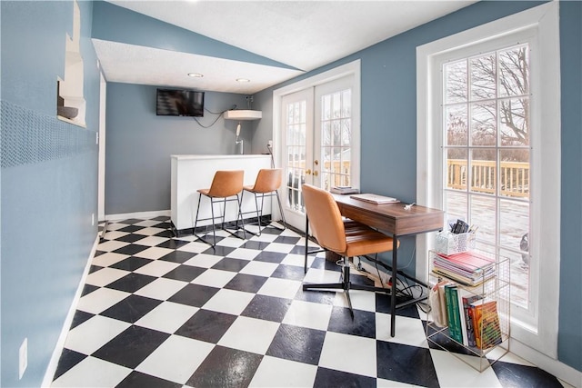 home office featuring lofted ceiling, french doors, baseboards, and tile patterned floors