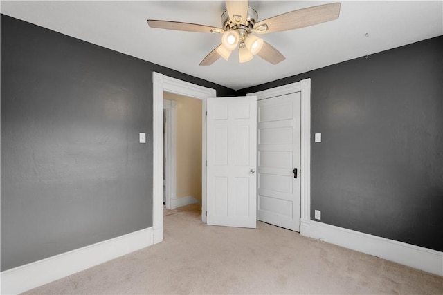 unfurnished bedroom with carpet, baseboards, and ceiling fan