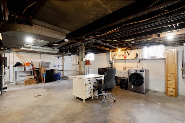 basement featuring a sink, washing machine and dryer, and a wealth of natural light