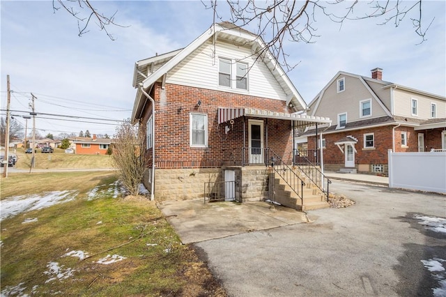 back of property featuring brick siding