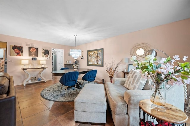 living room with tile patterned flooring, visible vents, a chandelier, and baseboards