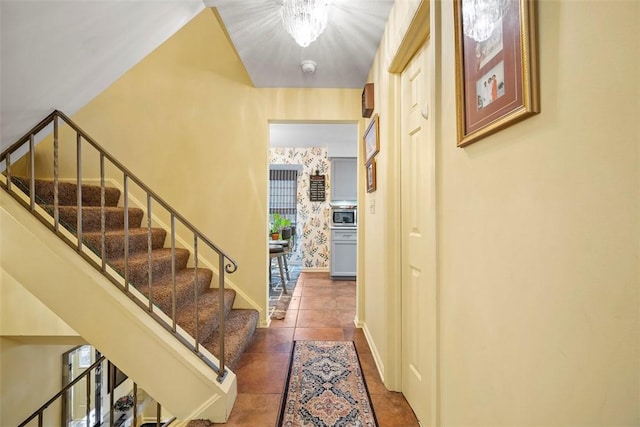 interior space with wallpapered walls, stairway, baseboards, and tile patterned floors