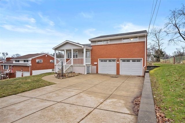 view of front of property with brick siding, a porch, a front yard, a garage, and driveway