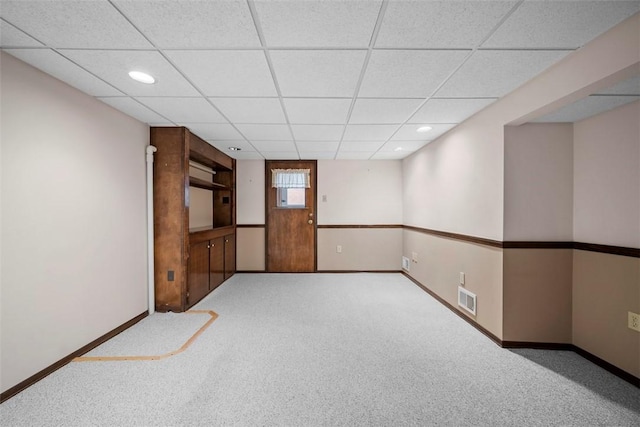 unfurnished room with a drop ceiling, recessed lighting, visible vents, baseboards, and carpet