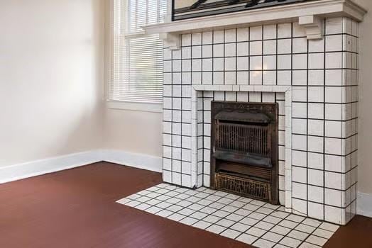 room details featuring a fireplace and baseboards