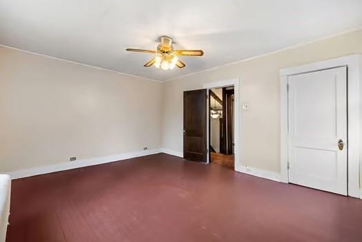 unfurnished bedroom with ceiling fan, finished concrete floors, baseboards, and a closet