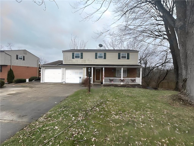 view of front of house featuring covered porch, driveway, and a front lawn