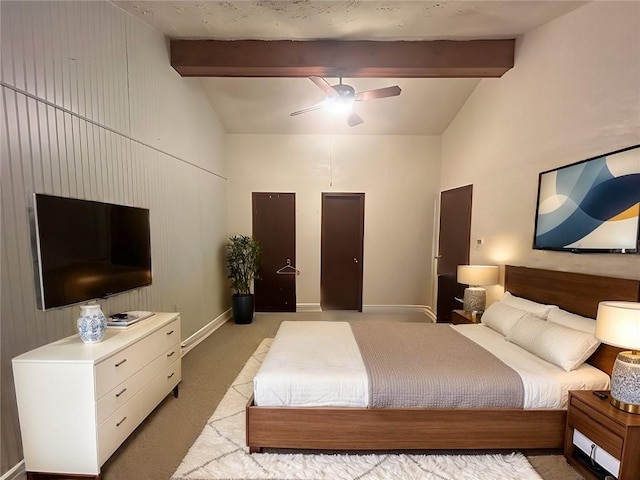 bedroom with lofted ceiling with beams, ceiling fan, baseboards, and light colored carpet