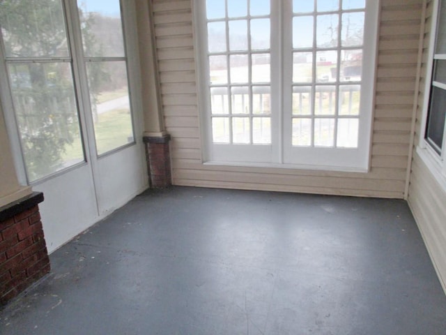 unfurnished sunroom featuring a wealth of natural light