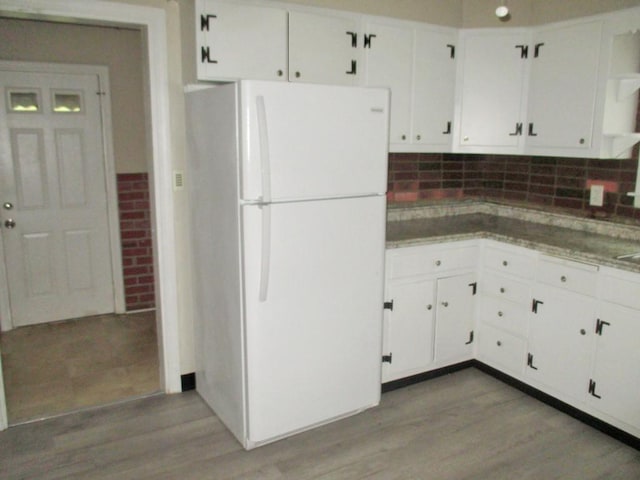 kitchen featuring white cabinets, light wood-style floors, open shelves, and freestanding refrigerator