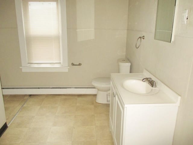 bathroom featuring a baseboard radiator, vanity, and toilet