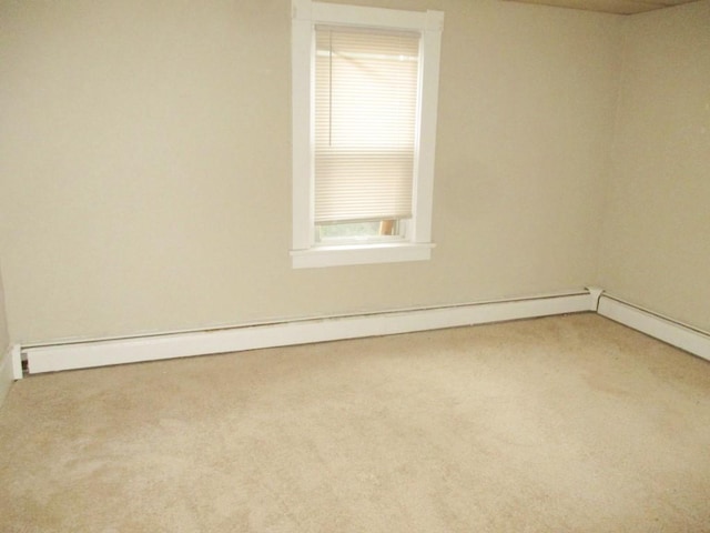 unfurnished room featuring carpet and baseboard heating