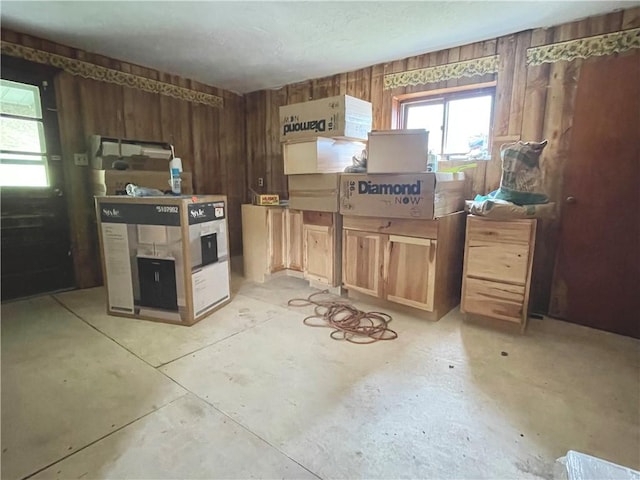 kitchen with wooden walls and concrete flooring