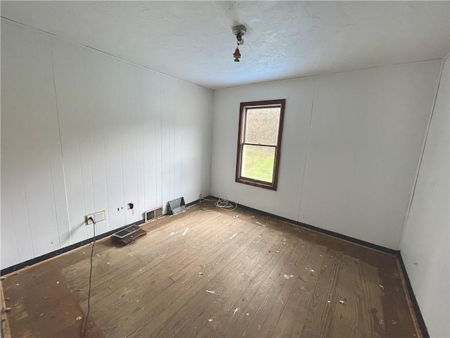 unfurnished room featuring hardwood / wood-style floors