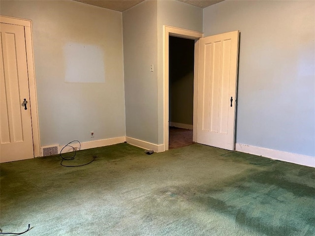 carpeted empty room with visible vents and baseboards