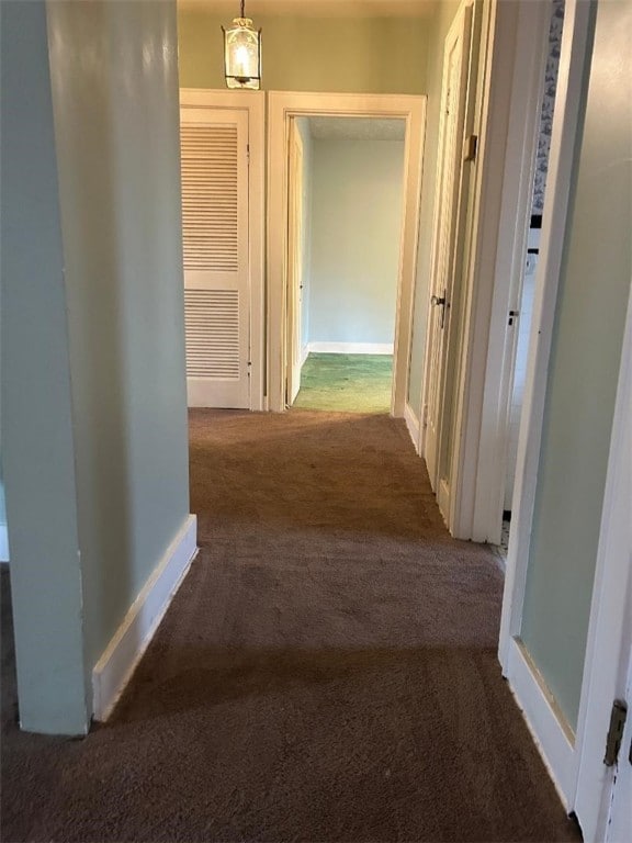 corridor featuring carpet and baseboards