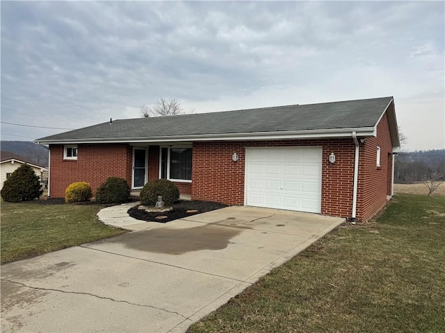 ranch-style house featuring a garage, driveway, brick siding, and a front yard