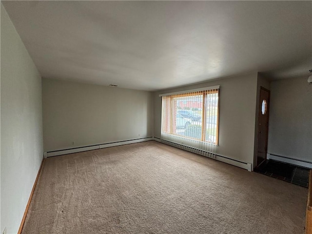 empty room with carpet floors and baseboard heating