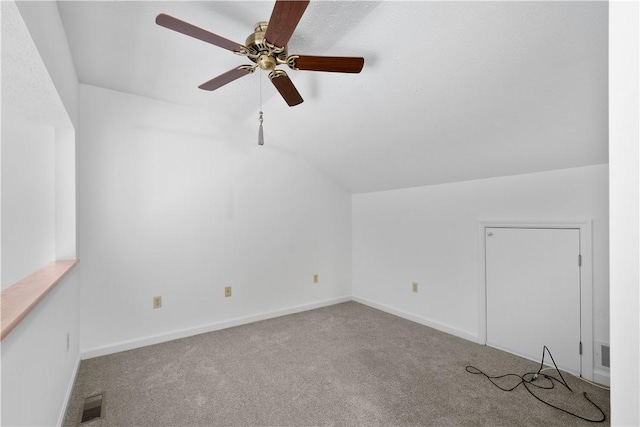 additional living space with carpet floors, lofted ceiling, visible vents, ceiling fan, and baseboards