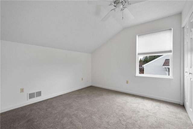 additional living space with baseboards, visible vents, lofted ceiling, ceiling fan, and carpet floors