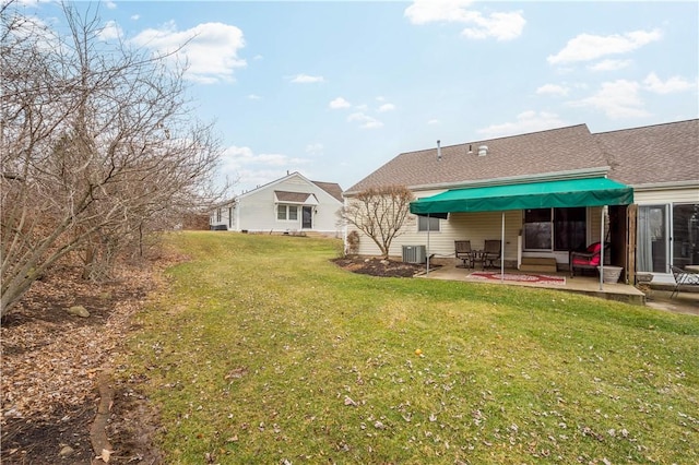 rear view of house featuring central AC, a lawn, and a patio area