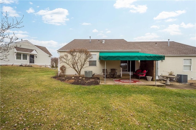 rear view of property featuring a yard, central AC, and a patio