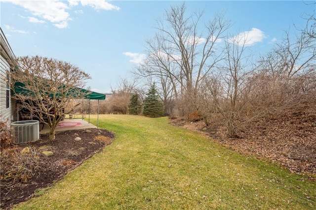 view of yard featuring cooling unit and a patio