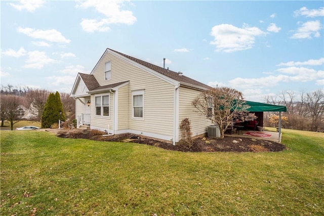 view of side of home with a lawn