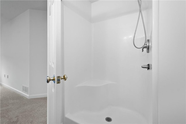 full bathroom featuring baseboards, visible vents, and walk in shower