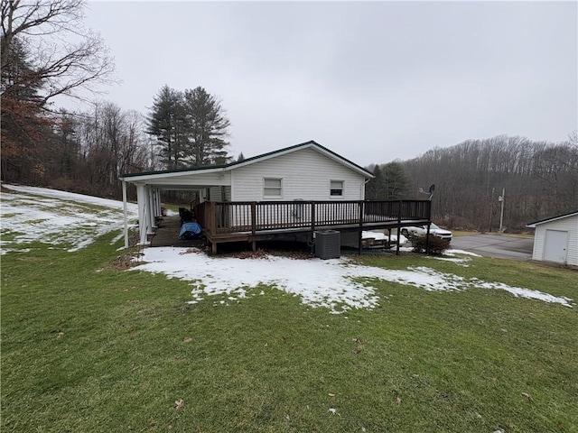 exterior space with a front yard and a wooden deck