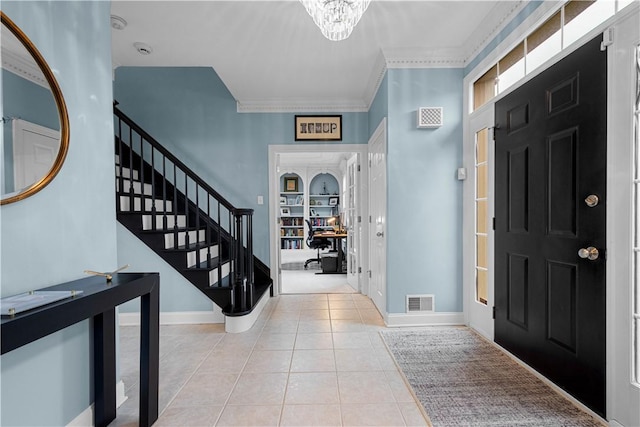 entryway with baseboards, an inviting chandelier, visible vents, and tile patterned floors