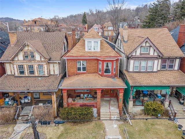 view of front facade featuring roof with shingles and a residential view