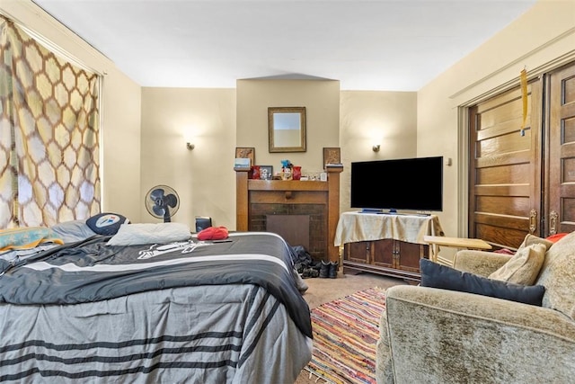 bedroom featuring carpet and a fireplace