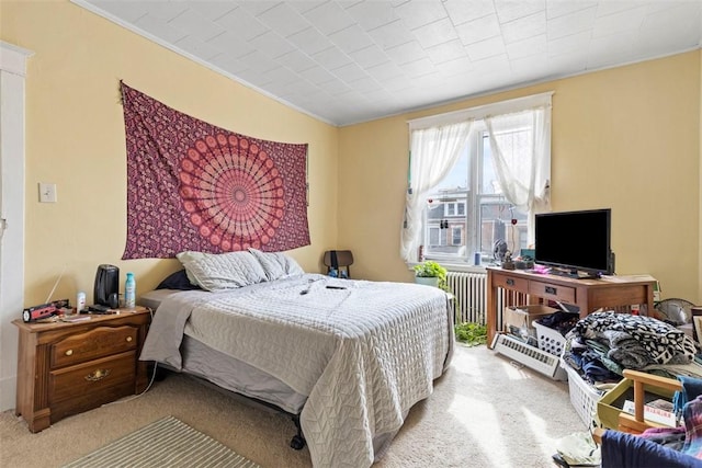 bedroom featuring radiator heating unit and light colored carpet