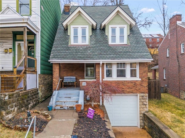 view of front of property with a garage, stone siding, concrete driveway, and brick siding