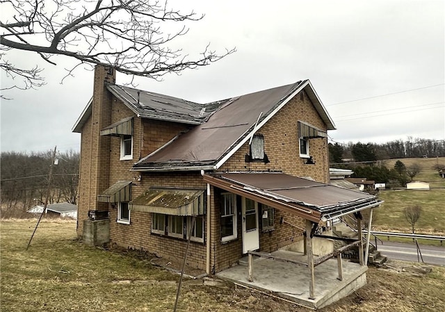 back of property with a chimney