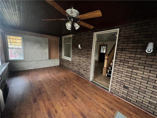 unfurnished sunroom featuring a ceiling fan